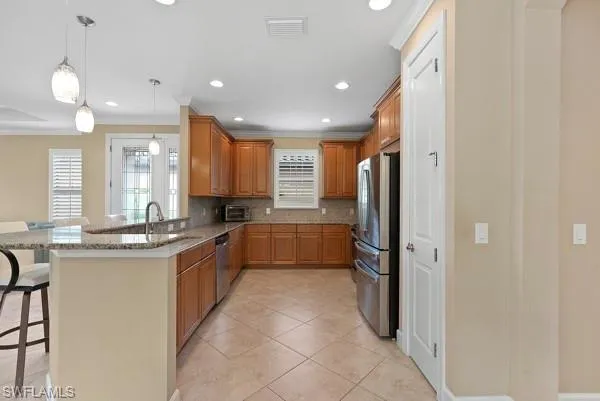 a large kitchen with a large counter top appliances and cabinets