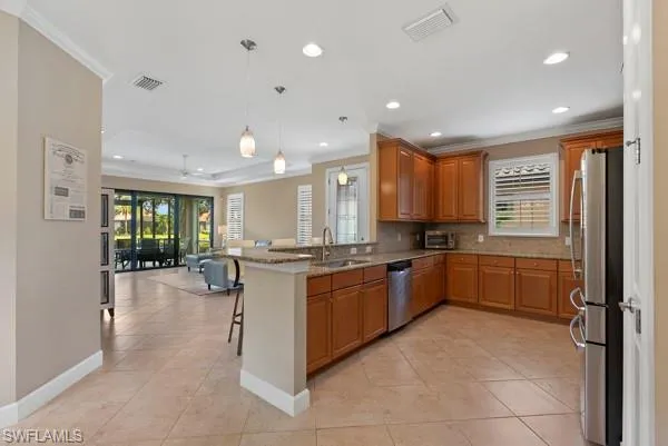 a large kitchen with stainless steel appliances lots of counter top space