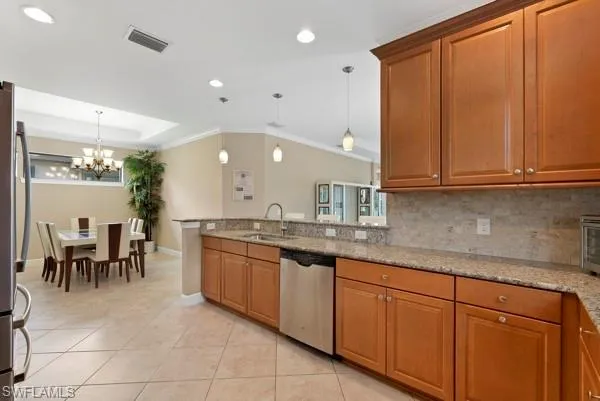a kitchen with stainless steel appliances granite countertop sink and cabinets