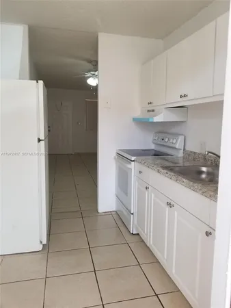 a kitchen with a sink a stove and refrigerator