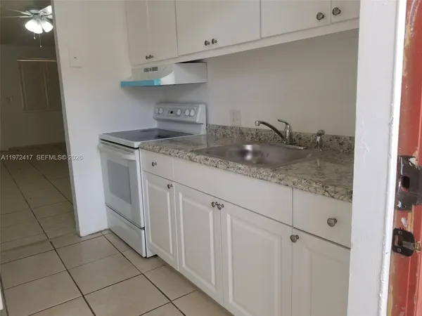 a kitchen with stainless steel appliances granite countertop a sink and cabinets