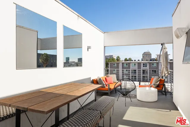 a view of a kitchen with kitchen island and stainless steel appliances