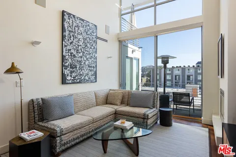 a kitchen with stainless steel appliances a stove a sink a refrigerator and cabinets