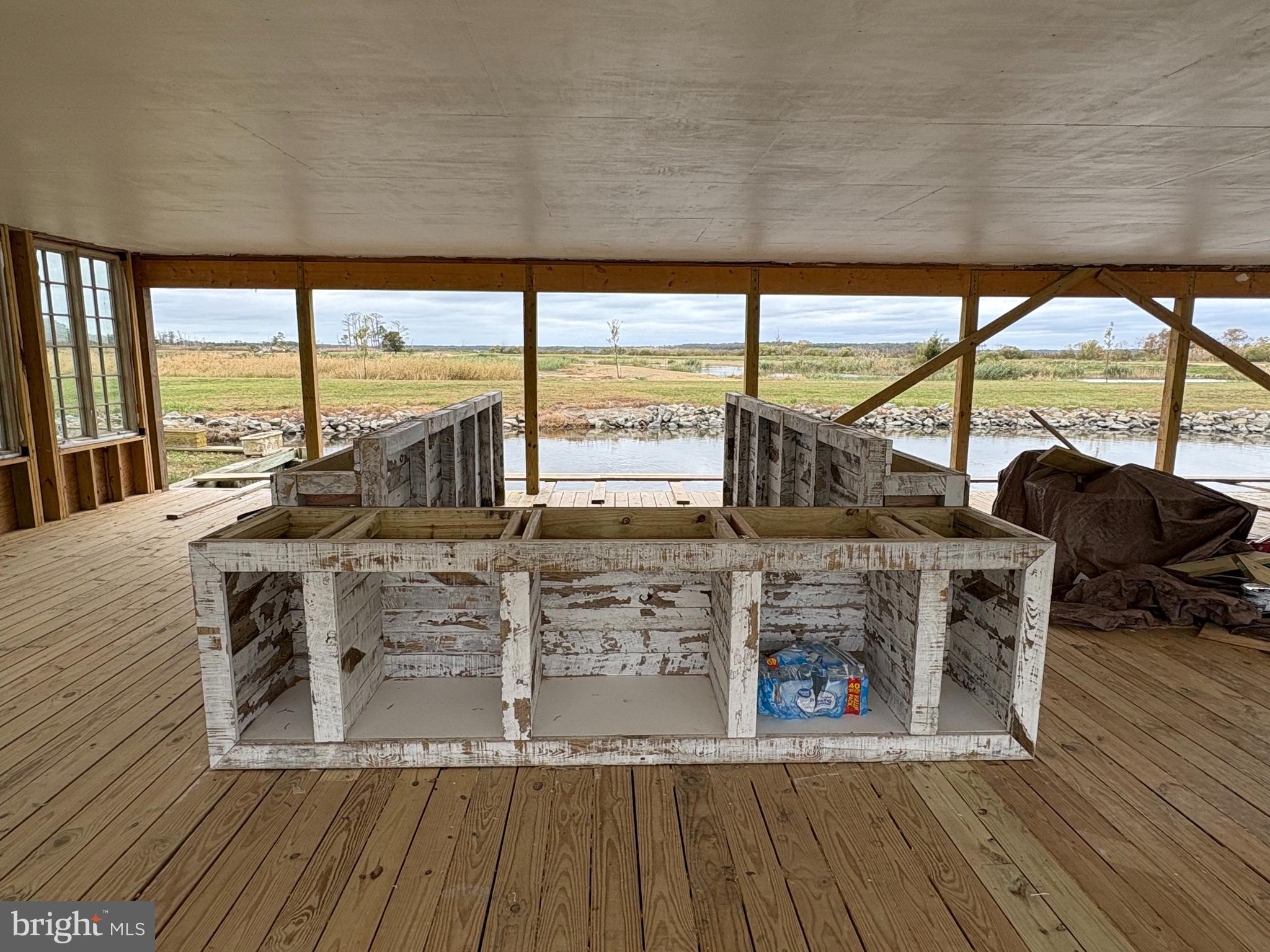 964 Taylors Island Road Madison, MD 21648 - Photo 102 of 106 a living room with furniture a large window and wooden floor