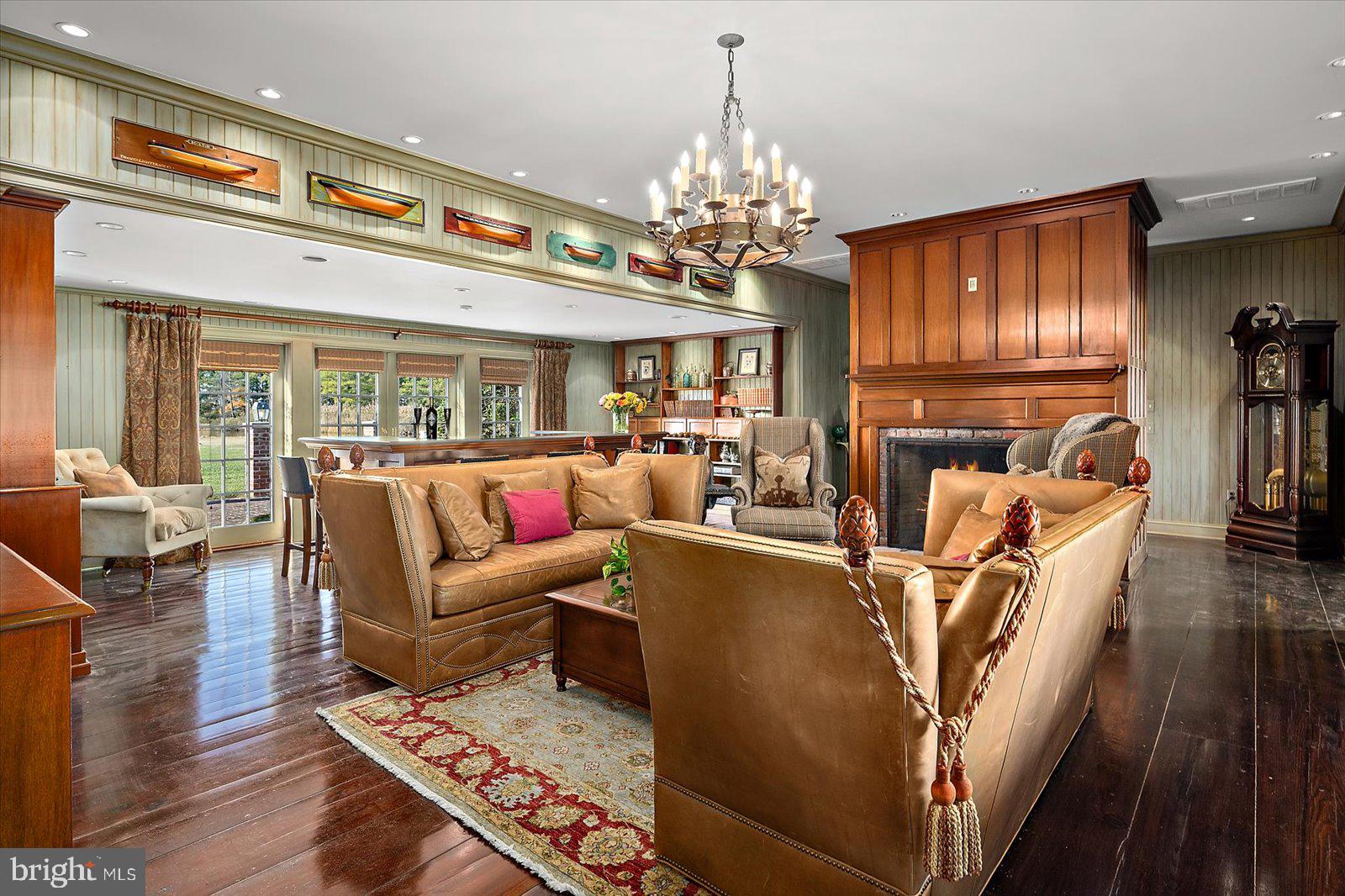 964 Taylors Island Road Madison, MD 21648 - Photo 16 of 106 a living room with furniture a chandelier and a dining table