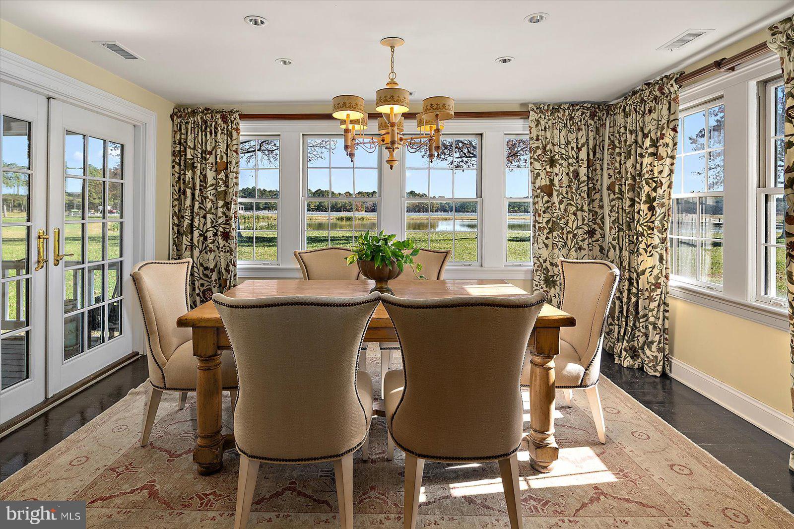 964 Taylors Island Road Madison, MD 21648 - Photo 22 of 106 a view of a dining room with furniture window and wooden floor
