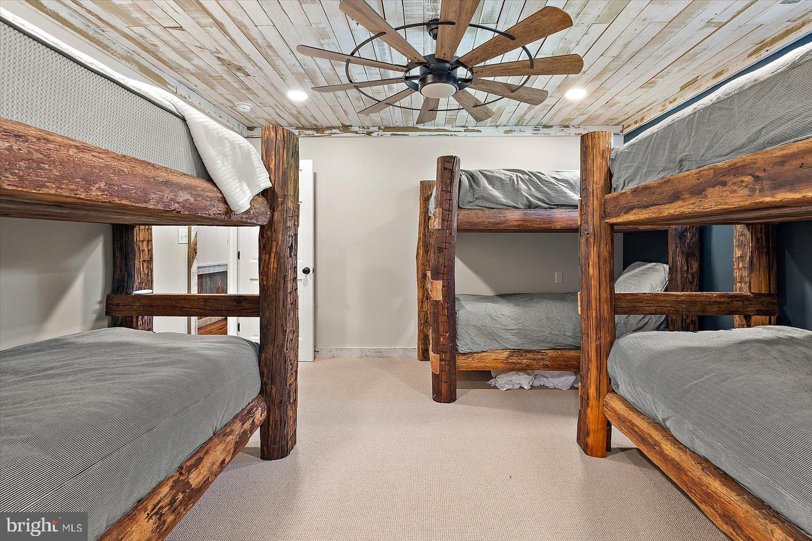 964 Taylors Island Road Madison, MD 21648 - Photo 74 of 106 a bedroom with a bed and a chandelier