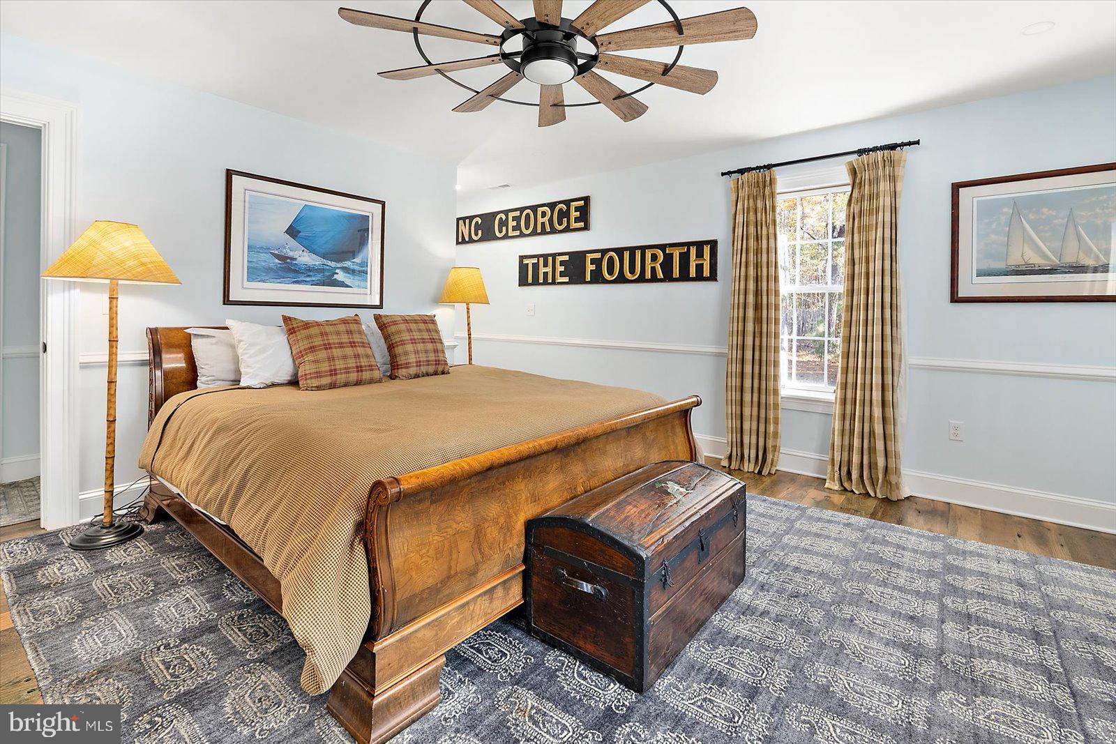 964 Taylors Island Road Madison, MD 21648 - Photo 83 of 106 a bedroom with a bed and a painting on the wall