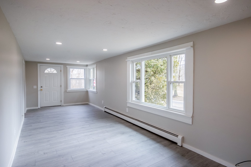 19 Oakham Road North Brookfield, MA 01535 - Photo 8 of 29 an empty room with windows