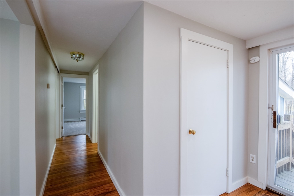 19 Oakham Road North Brookfield, MA 01535 - Photo 9 of 29 a view of a hallway with wooden floor and a bathroom