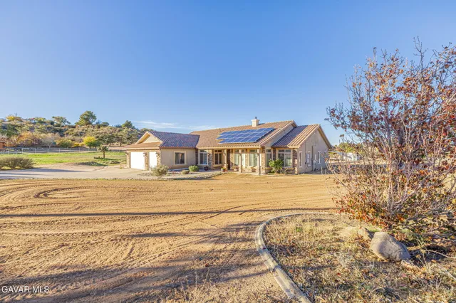 a view of a dining room with furniture and a chandelier