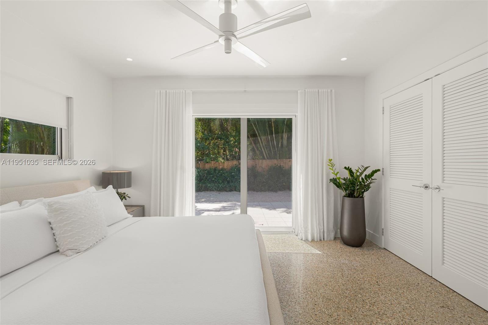 1040 Northeast 85th Street Miami, FL 33138 - Photo 14 of 22 a bedroom with a large bed and a potted plant