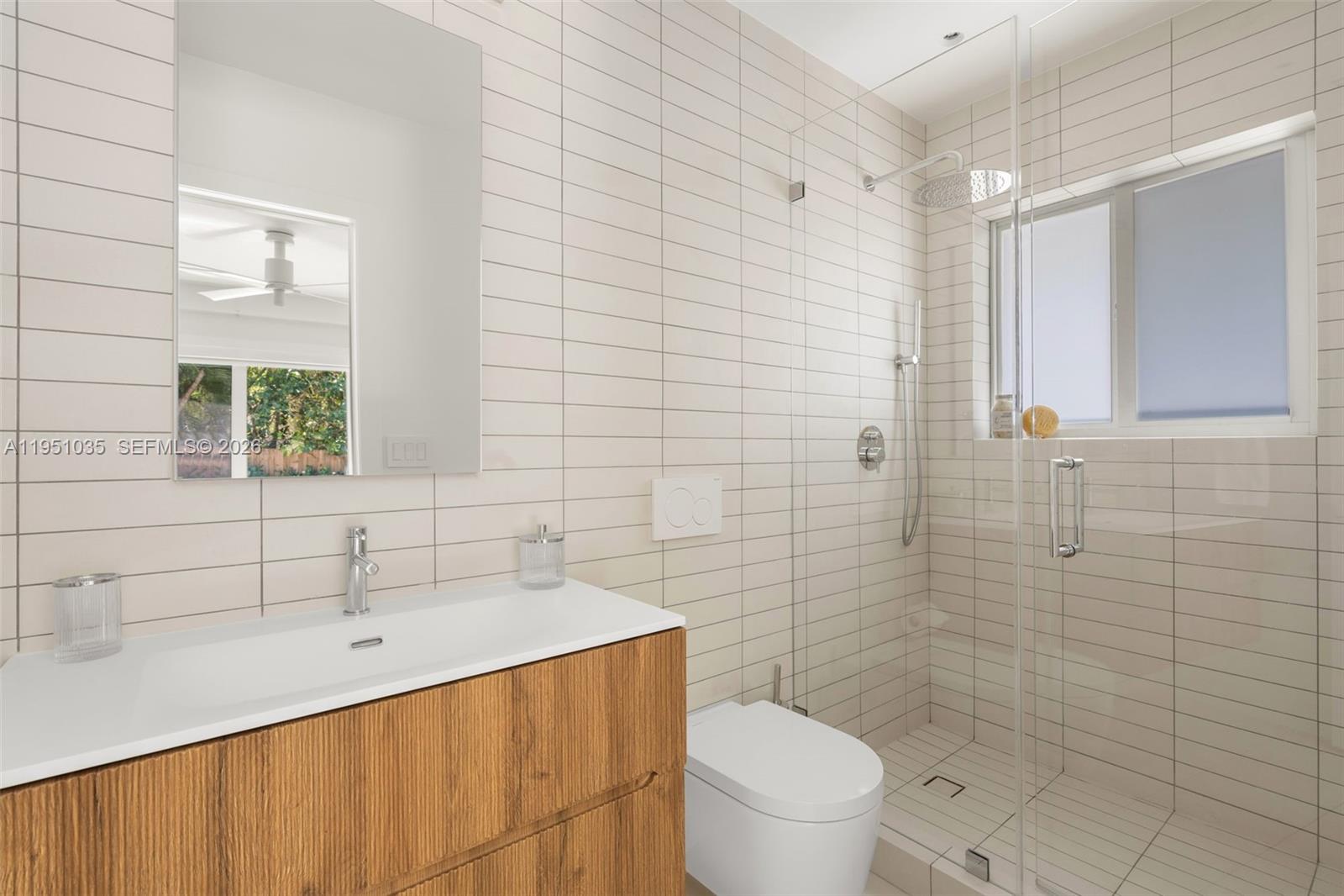 1040 Northeast 85th Street Miami, FL 33138 - Photo 15 of 22 a bathroom with a sink a toilet and shower