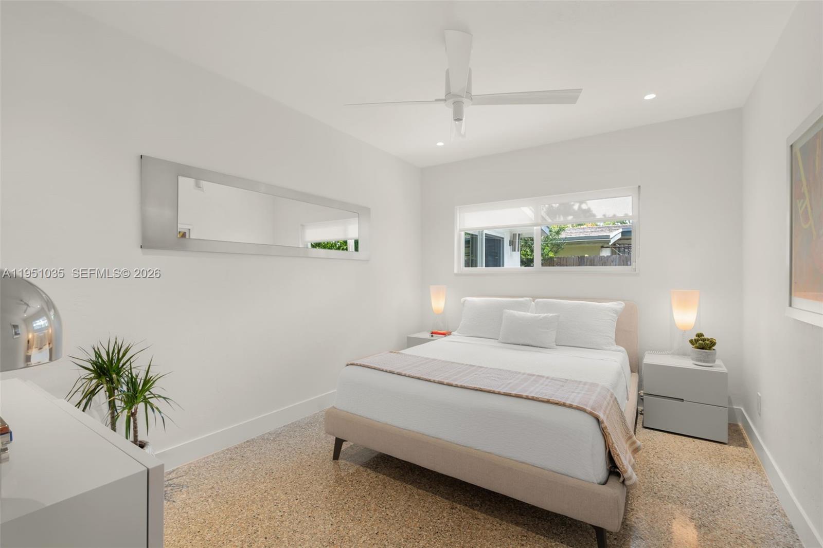 1040 Northeast 85th Street Miami, FL 33138 - Photo 16 of 22 a bedroom with a bed and a potted plant