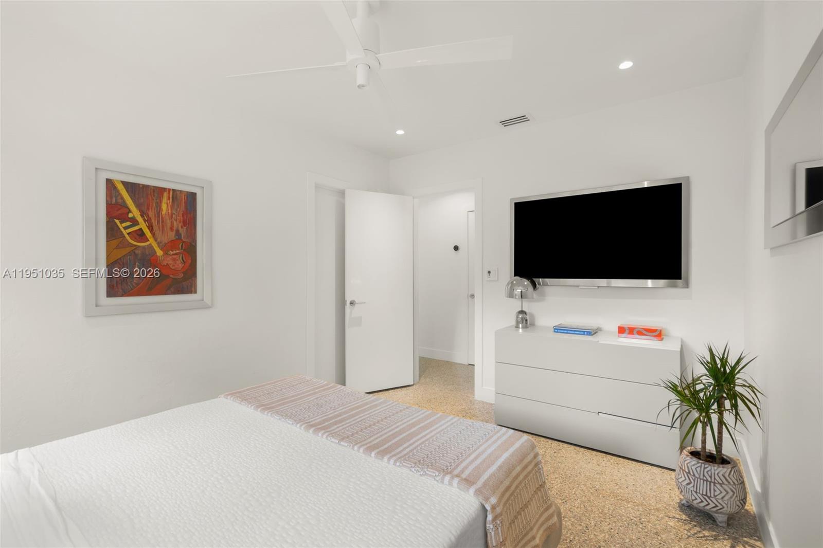 1040 Northeast 85th Street Miami, FL 33138 - Photo 17 of 22 a room with a bed and a flat screen tv