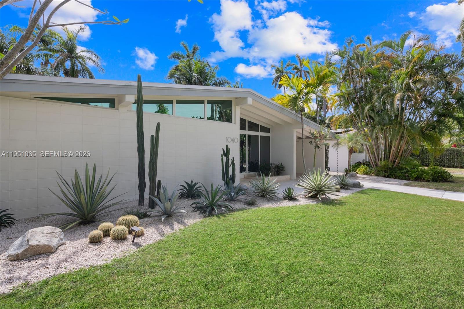 1040 Northeast 85th Street Miami, FL 33138 - Photo 2 of 22 a front view of a house with garden