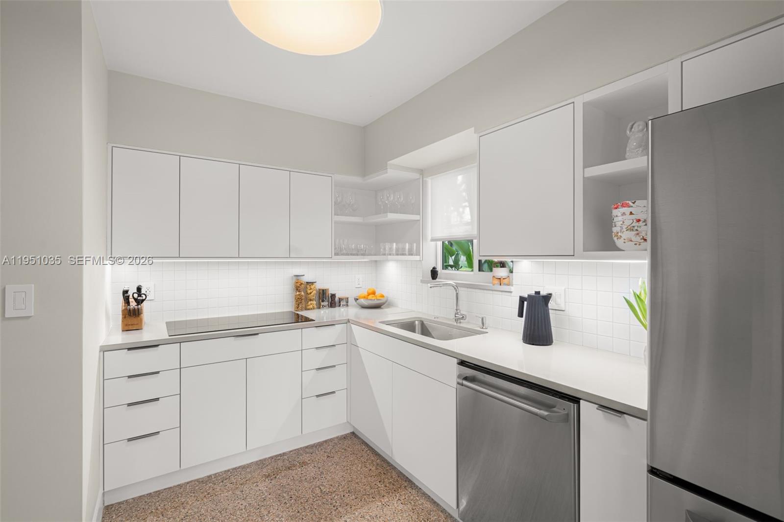 1040 Northeast 85th Street Miami, FL 33138 - Photo 9 of 22 a kitchen with a sink dishwasher window and cabinets