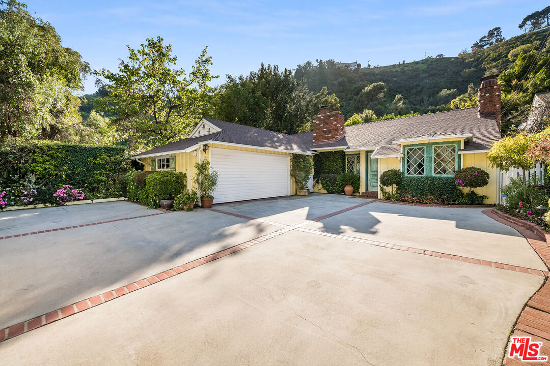 1725 Franklin Canyon Drive Beverly Hills, CA 90210 - Photo 1 of 18 front view of a house with a street