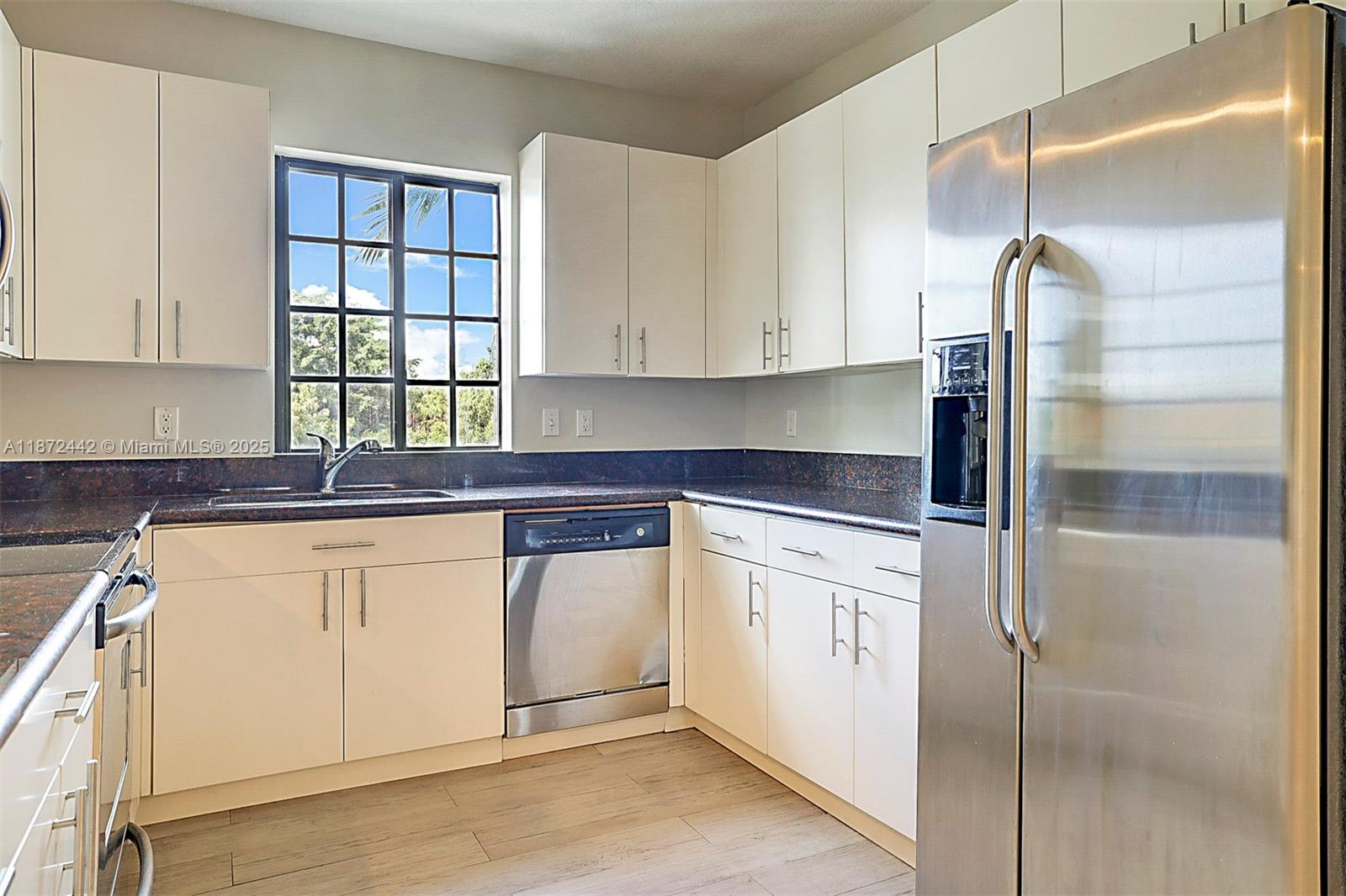 4905 Midtown Lane, Unit 2209 Palm Beach Gardens, FL 33418 - Photo 12 of 30 a kitchen with stainless steel appliances granite countertop a refrigerator and a sink
