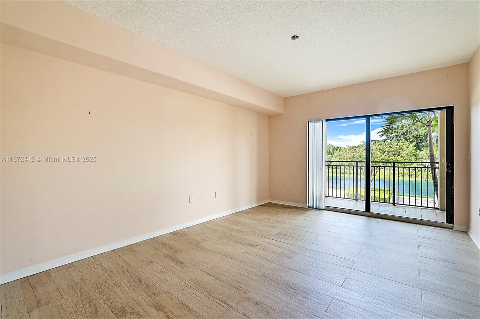 4905 Midtown Lane, Unit 2209 Palm Beach Gardens, FL 33418 - Photo 15 of 30 wooden floor in an empty room with a window