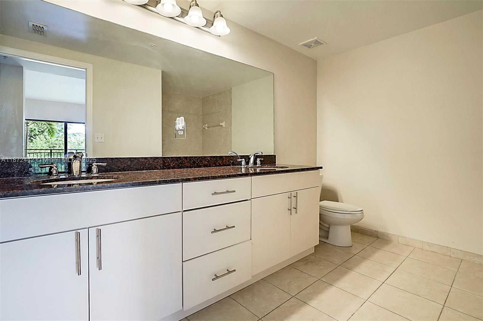 4905 Midtown Lane, Unit 2209 Palm Beach Gardens, FL 33418 - Photo 17 of 30 a bathroom with a toilet sink and mirror