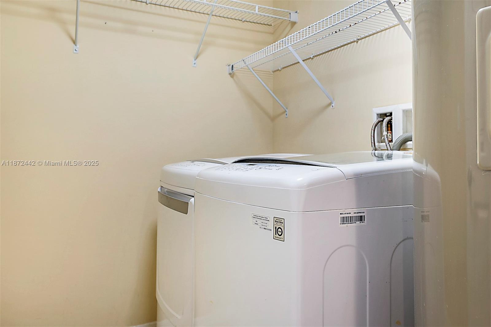 4905 Midtown Lane, Unit 2209 Palm Beach Gardens, FL 33418 - Photo 20 of 30 a utility room with dryer and washer