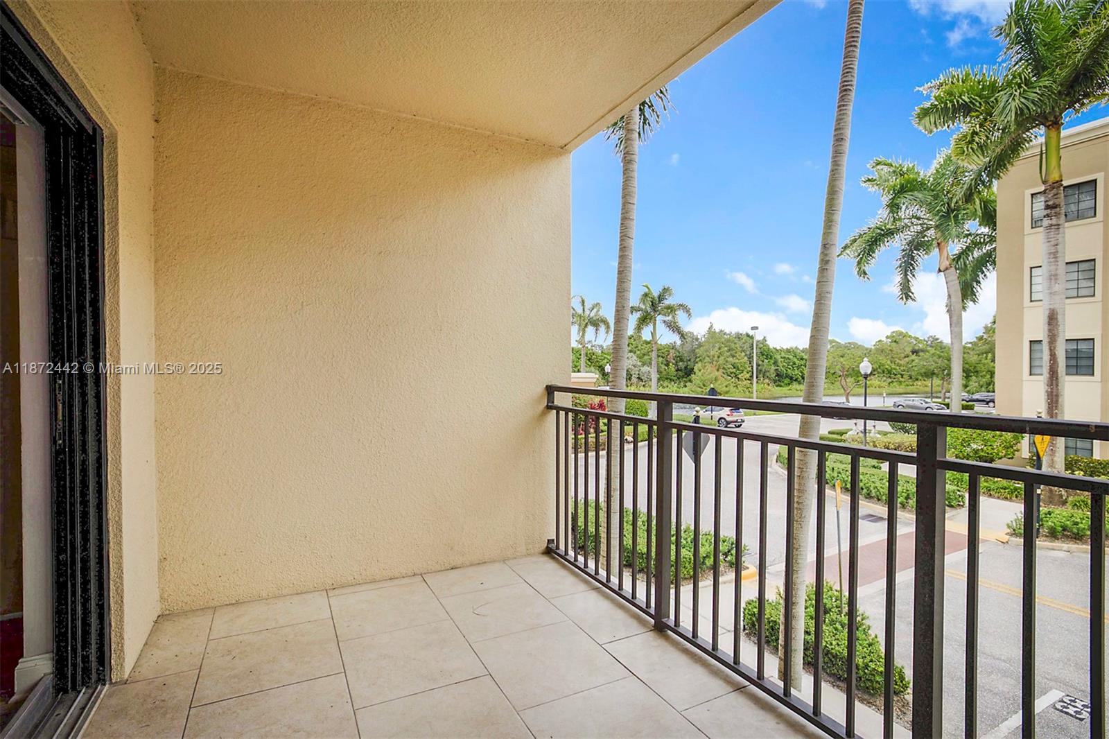 4905 Midtown Lane, Unit 2209 Palm Beach Gardens, FL 33418 - Photo 7 of 30 a view of a balcony with wooden floor and fence