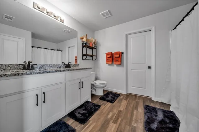 a spacious bathroom with a sink and a toilet