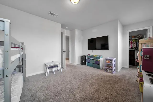 a view of a livingroom with furniture and a flat screen tv