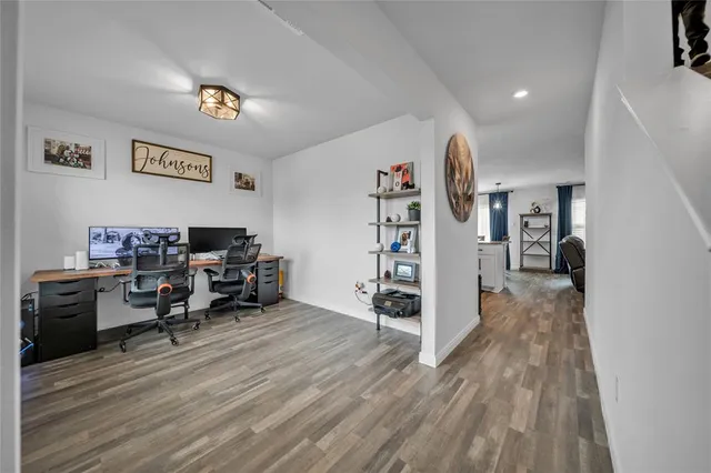 a view of a workspace with furniture and wooden floor
