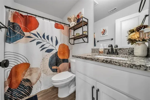 a bathroom with a toilet a sink and a mirror