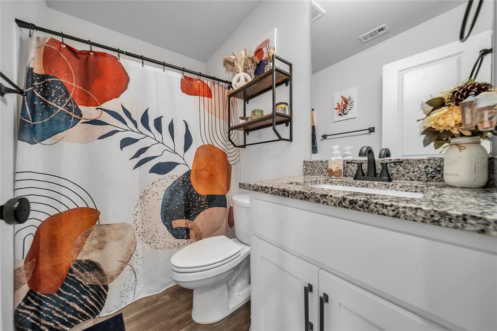 3581 Chestnut Oak Drive Dallas, TX 75253 - Photo 9 of 21 a bathroom with a toilet a sink and a mirror
