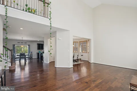 an empty room with wooden floor and a view