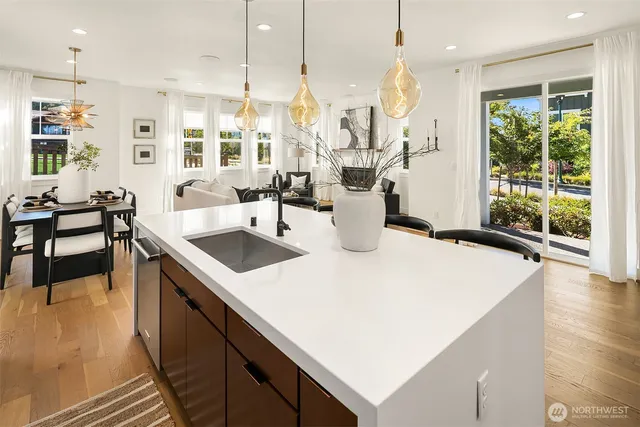 a kitchen with a sink a stove and chairs