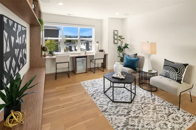 a living room with furniture and a potted plant
