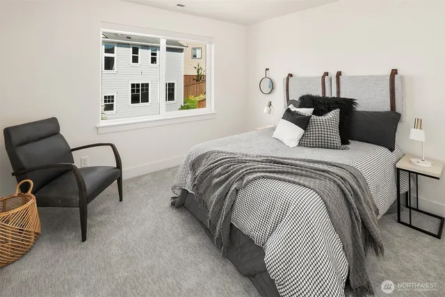 a bedroom with bed and a chair