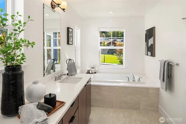 a bathroom with a granite countertop sink a toilet a shower and a mirror