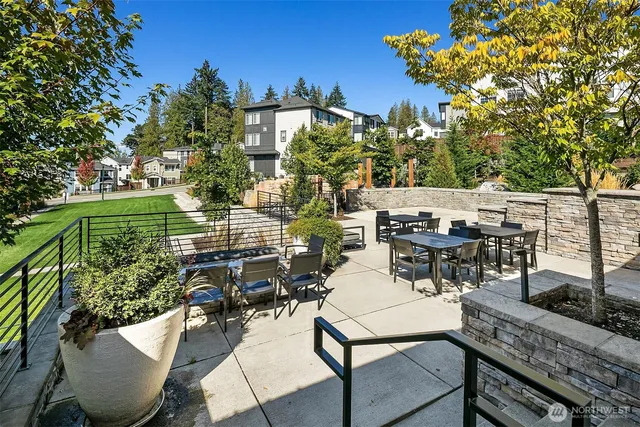 a view of a patio with table and chairs and potted plants