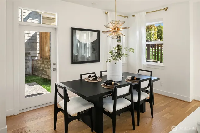 a view of a dining room with furniture window and wooden floor