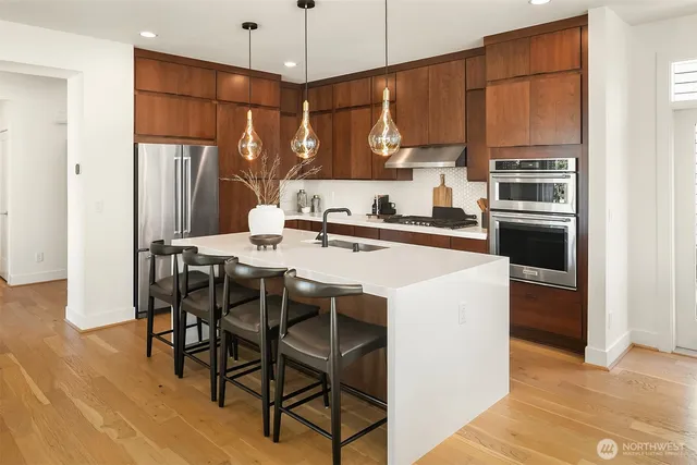 a kitchen with a table chairs refrigerator and microwave