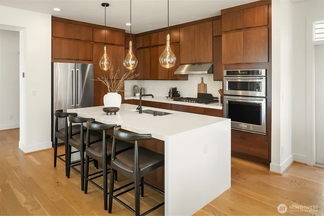 a kitchen with a table chairs refrigerator and microwave