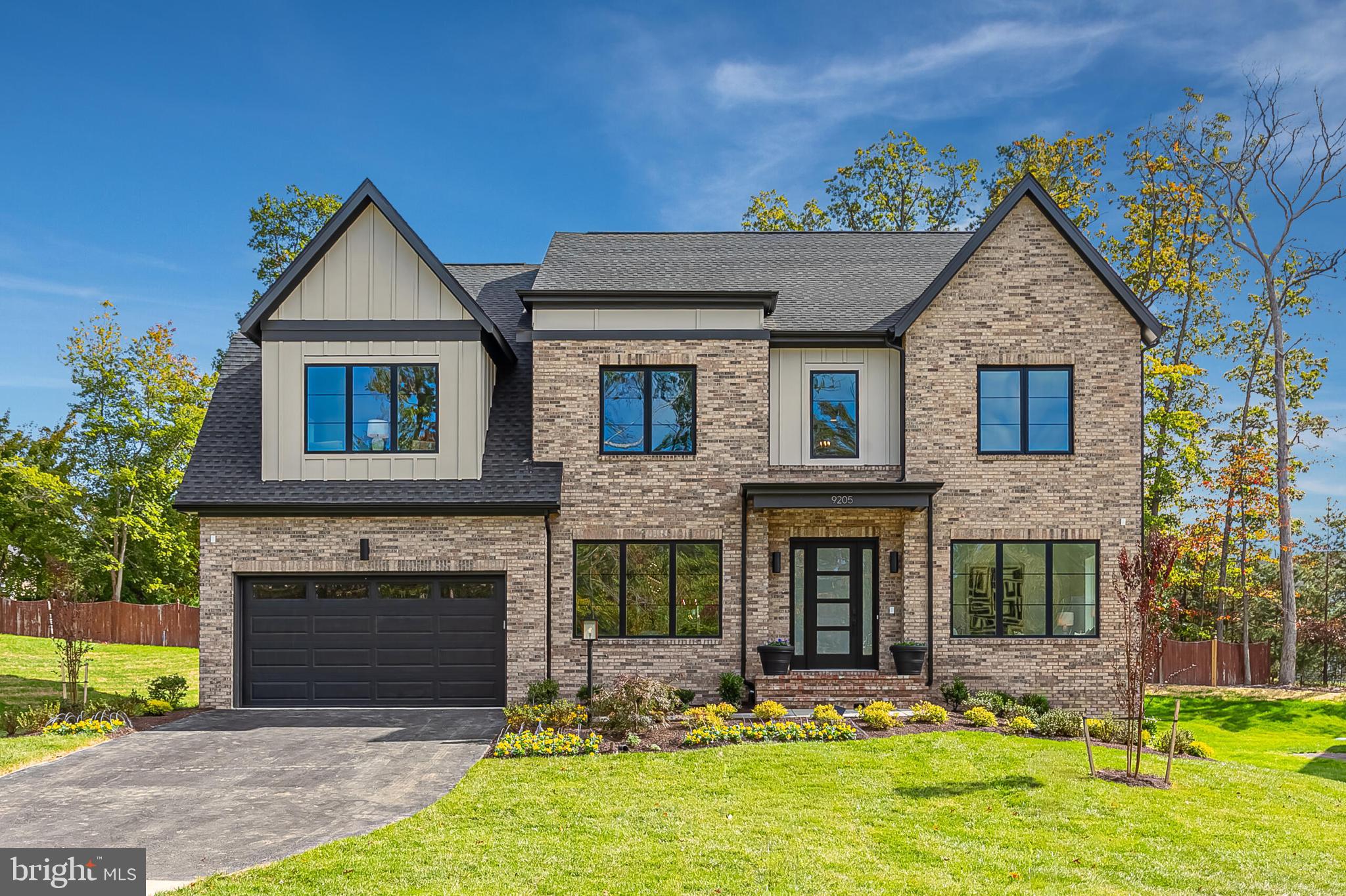a front view of a house with yard and garage