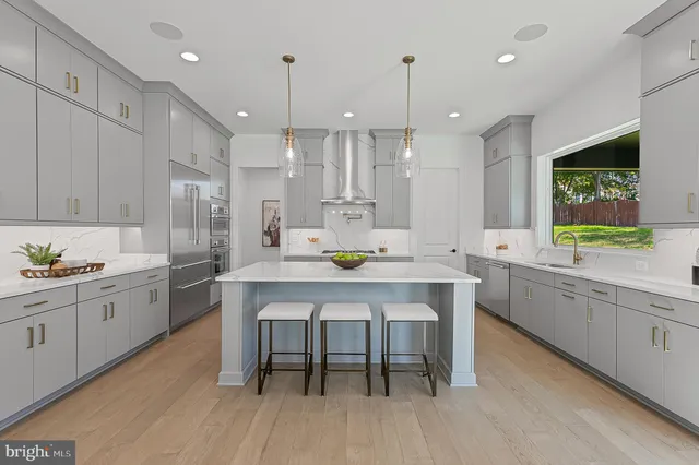 a large kitchen with a table and chairs in it