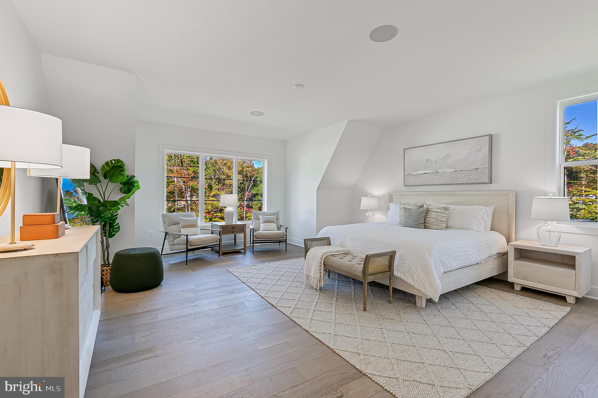 9205 Franks Point Lane Lorton, VA 22079 - Photo 17 of 26 a spacious bedroom with a bed a couch and potted plant on the table
