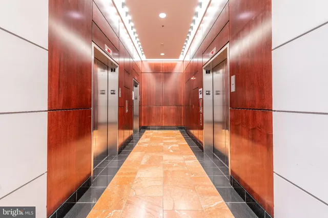 a lobby with furniture and a potted plant