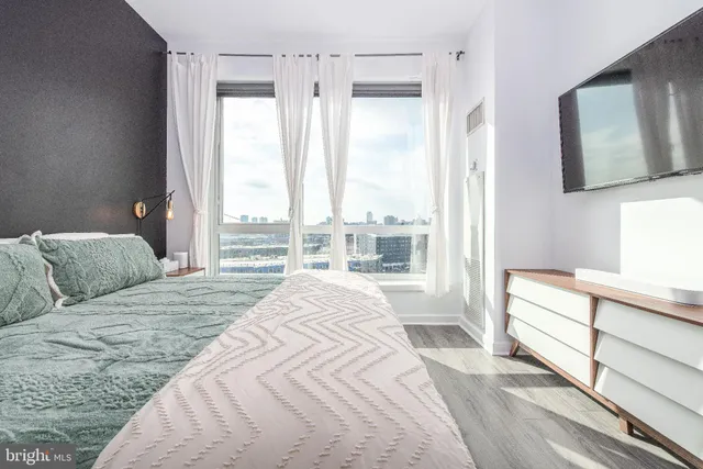 a bedroom with a large bed and a large window