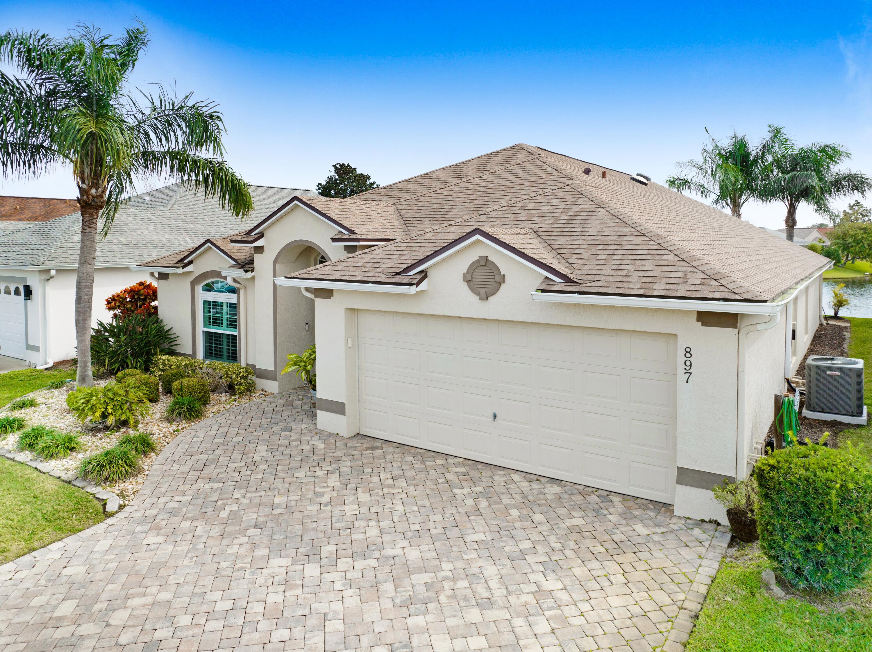 897 Shaw Circle Melbourne, FL 32940 - Photo 2 of 57 front view of a house with a yard