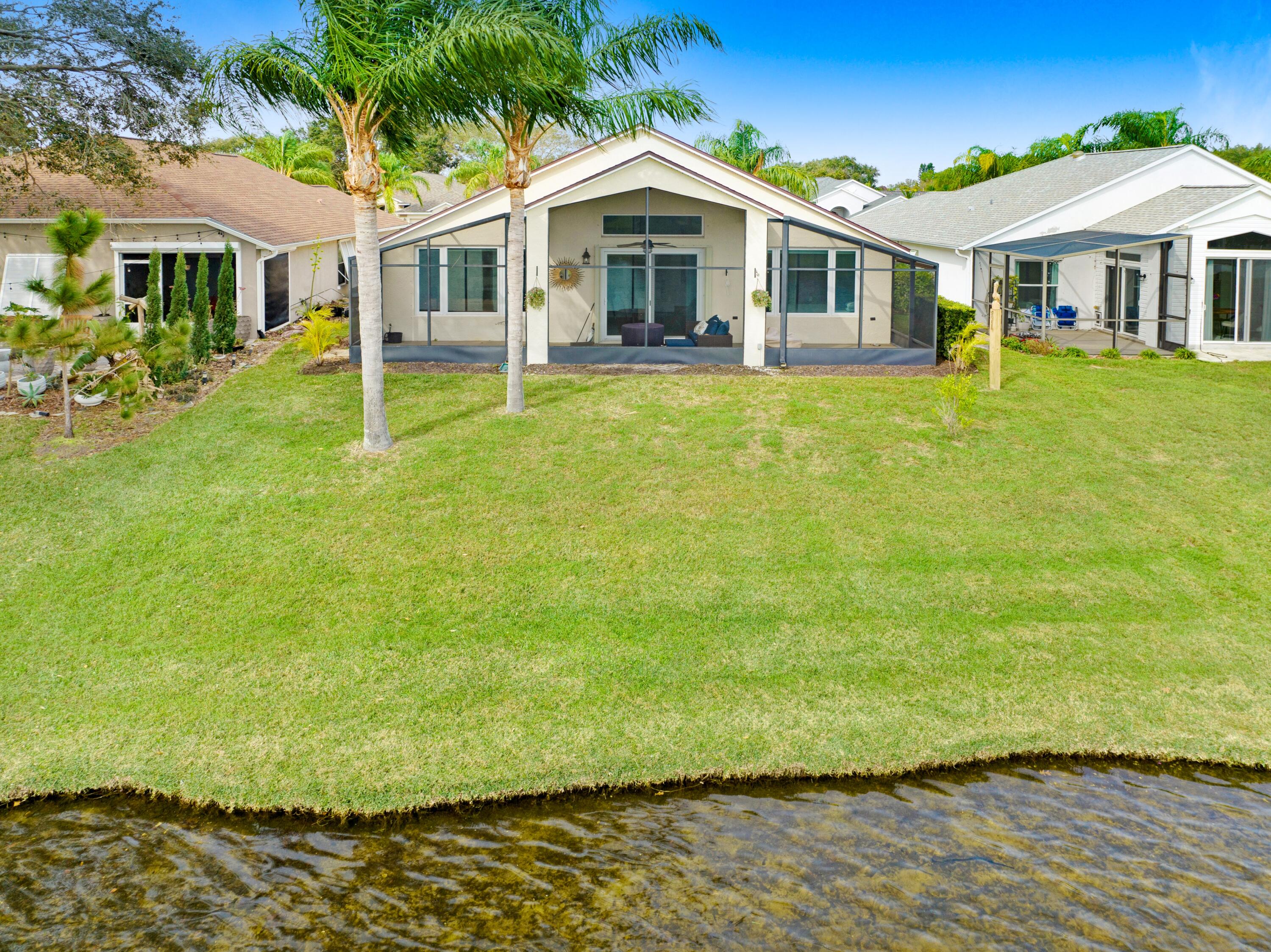 897 Shaw Circle Melbourne, FL 32940 - Photo 23 of 57 a front view of a house with a yard
