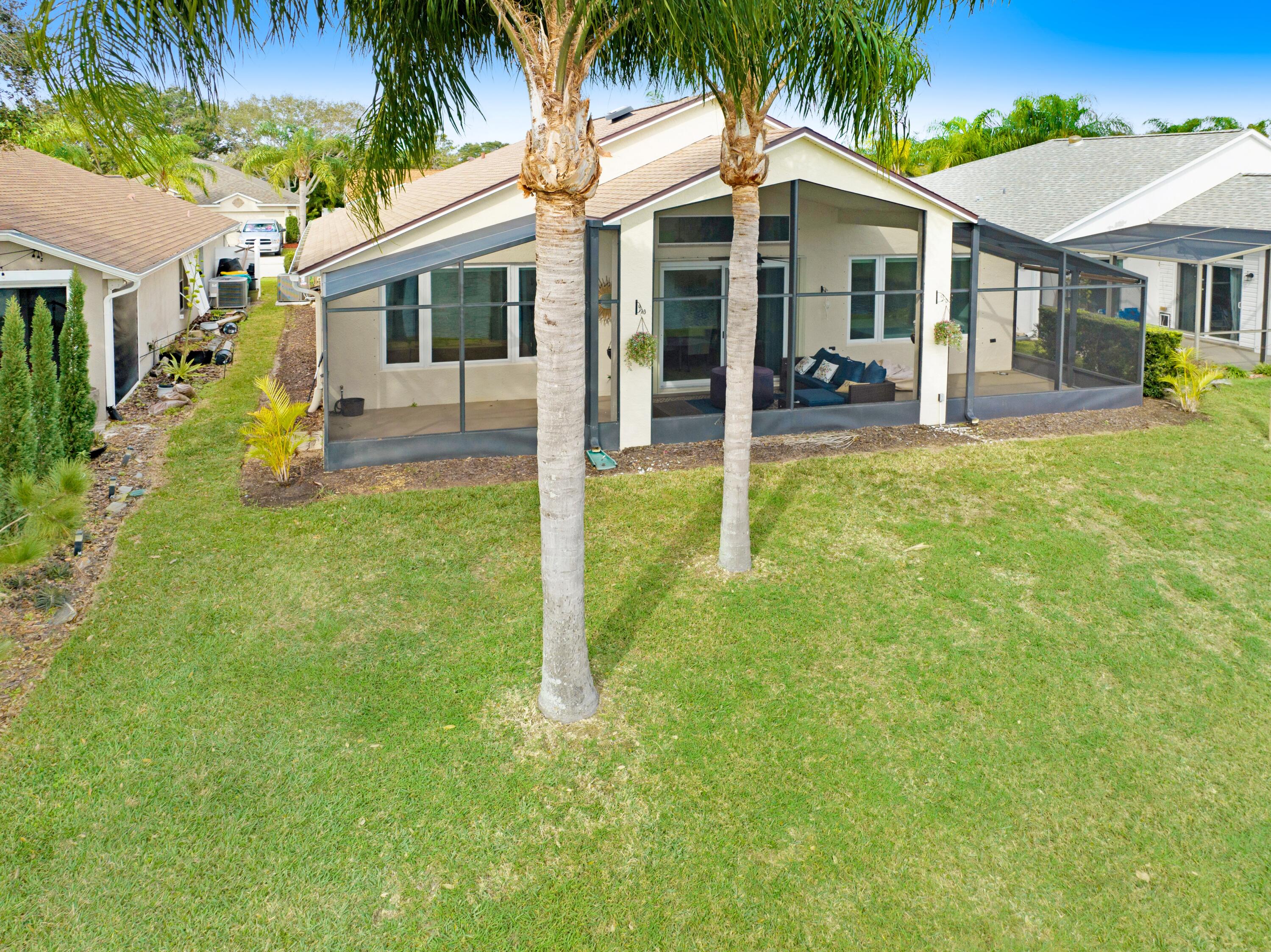 897 Shaw Circle Melbourne, FL 32940 - Photo 24 of 57 a front view of a house with a yard and porch