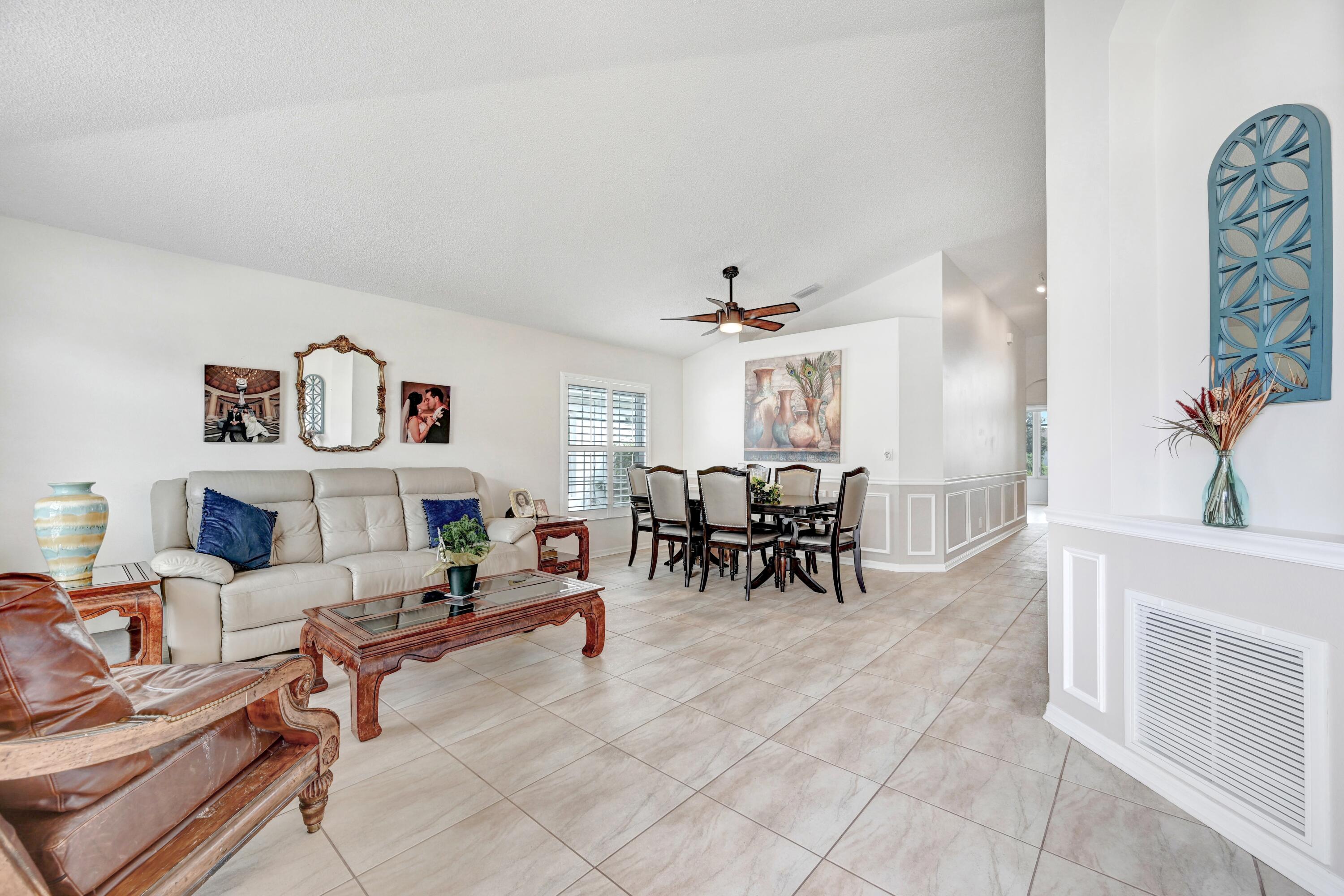 897 Shaw Circle Melbourne, FL 32940 - Photo 25 of 57 a living room with furniture and a potted plant